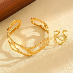 Detailed close-up of 18K gold-plated irregular wavy texture bracelet and matching ring set