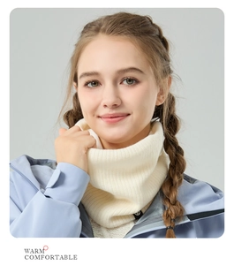 Detail of cream white cable knit winter neck warmer with warm fleece lining texture