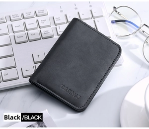 Close-up of black leather wallet with texture, stitching, and brand logo on desk