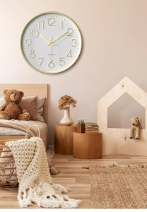 Detail of modern 30cm wall clock with 3D gold numerals and silent quartz movement