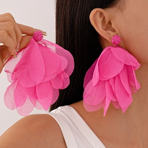 Exaggerated rose pink chiffon petal earrings with woven stud on model for summer