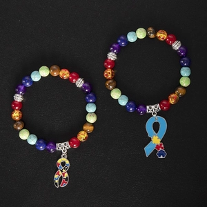 Detail of autism awareness stretch bracelets with colorful stone beads and enamel charms