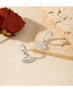 Close-up of S925 sterling silver evil eye earrings with pavé cubic zirconia inlay