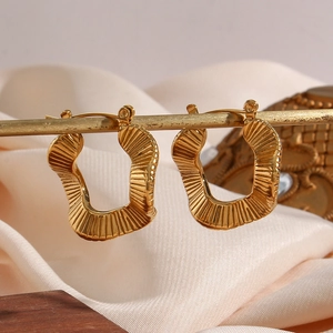 Irregular textured gold hoop earrings in 18K plated stainless steel with pleated design