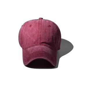 Macro detail of the washed cotton fabric texture on a wine red vintage baseball cap