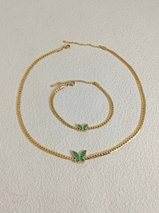 Detail of 18k gold plated stainless steel bracelet with green butterfly shell pendant