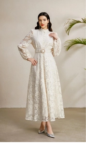 Detail of white lace dress with stand collar, puff sleeves, and matching belt