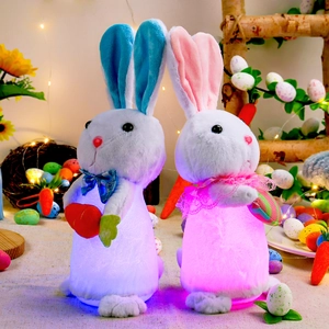 Glow-in-the-dark plush Easter bunnies with LED lights holding carrots for home decoration