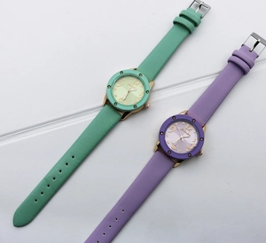 Detailed close-up of vintage quartz watches with green and purple PU leather straps