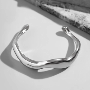 Polished silver irregular wave cuff bracelet for men with a minimalist hip-hop aesthetic