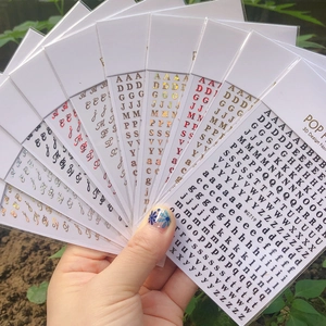 Detailed view of 3D colorful English alphabet nail art stickers in various metallic finishes