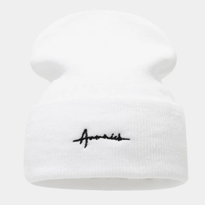 Close-up of white knitted beanie with black cursive letter embroidery on the front cuff