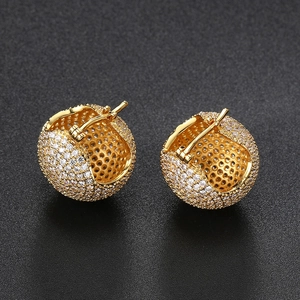 Macro view of gold plated sphere hoop earrings featuring pavé cubic zirconia setting