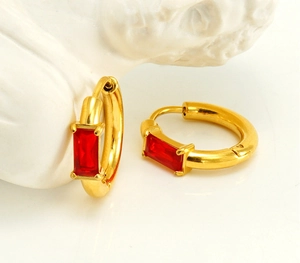 Detail of gold-plated stainless steel hoop earrings with rectangular red zircon inlay