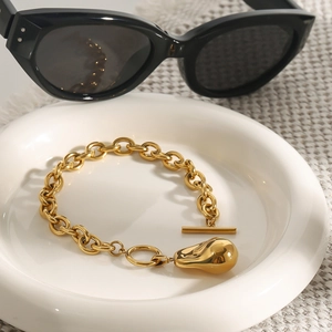 Polished gold link bracelet with a water drop pendant and toggle clasp closure