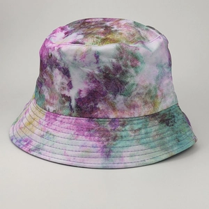 Close-up detail of tie-dye bucket hat showing purple and yellow twill cotton texture