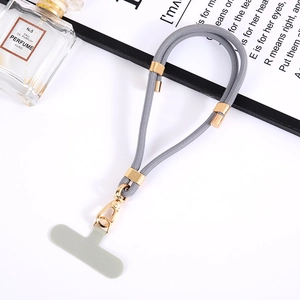 Grey nylon adjustable phone lanyard with gold metal buckle and connector tab on tray
