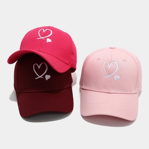 Three cotton baseball caps with heart embroidery in rose, burgundy, and light pink colors