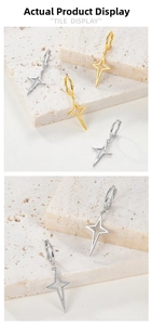 Detailed close-up of 925 sterling silver star pendant earrings in gold and silver finish
