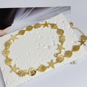 Detail of 18K gold plated starfish and seashell ocean charms on an adjustable necklace