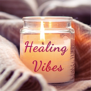 Close-up of a lit scented candle in a glass jar wrapped in a cozy knitted blanket