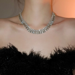 Detailed view of silver baguette-cut crystal choker necklace on female model neck