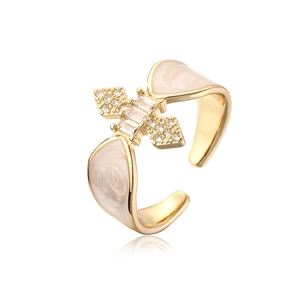 Detail of 18K gold plated ring with beige enamel and micro-set cubic zirconia stones