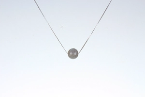 Macro detail of natural labradorite pendant with blue sheen on a silver chain