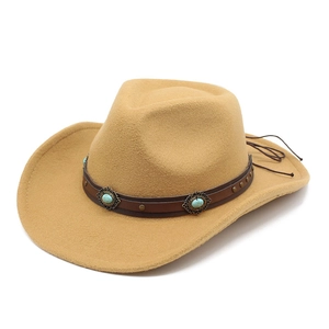 Detail of western cowboy felt hat with camel wide brim and turquoise leather band