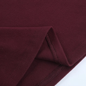 Macro view of burgundy knitted fabric texture with professional stitching details