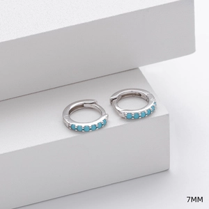 Macro detail of 925 sterling silver huggie earrings with turquoise blue stones and 7mm size
