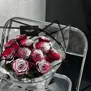 Frosted deep red roses bouquet in geometric wrapping for elegant holiday gifts