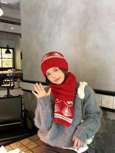 Dettaglio del berretto in maglia rossa Fair Isle con fiocchi di neve e alberi