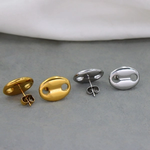 Macro detail of oval coffee bean stud earrings in gold and silver stainless steel finish