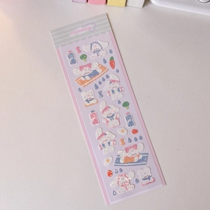 Close-up of holographic PET stickers featuring cute cartoon dog and purple aesthetic