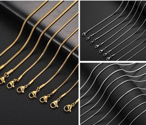 Close-up of gold and silver stainless steel snake chains with secure lobster clasp closures