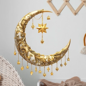 Golden crescent moon wall decor with white floral patterns and hanging star pendants