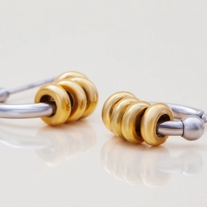 Minimalist small C-shaped earrings in two-tone 18K gold and stainless steel silver