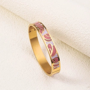 Detail of 18K gold plated stainless steel bangle with pink and purple enamel wave pattern