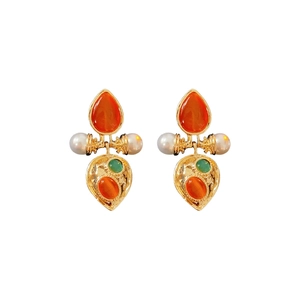 Vintage palace style gold earrings with cat eye stones and pearls on white background