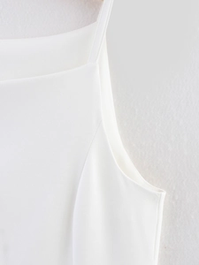Detail shot of white camisole top showing the fine twill fabric and shoulder strap stitching