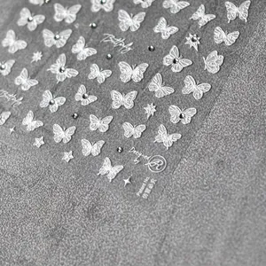 Lustrous white butterfly nail art stickers with delicate rhinestones and stars