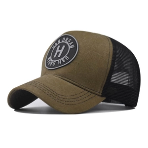 Detail of H&H DREAM logo on a vintage washed trucker hat with breathable mesh back