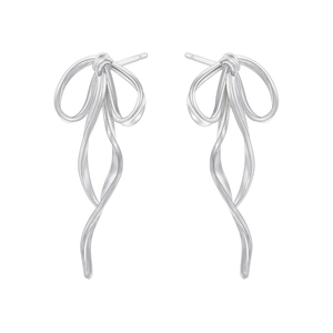 Detailed view of silver bow-shaped ribbon earrings with a polished metallic finish