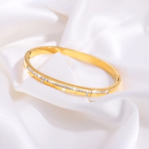 Close-up of golden titanium steel bracelet with Roman numerals and paved diamonds on white silk