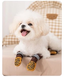 Detail view of non-slip dog socks with yellow grip soles and gray velcro straps