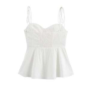 Detailed back view of white peplum camisole with smocked back and thin straps