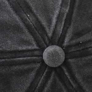 Detail of the stitched top button and six-panel seam on a washed cotton baseball cap