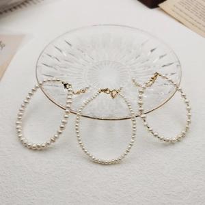 Close-up of handmade freshwater pearl bracelet with golden lobster clasp and jewelry tray