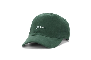 Close-up of cotton twill baseball cap in dark green with me embroidery detail